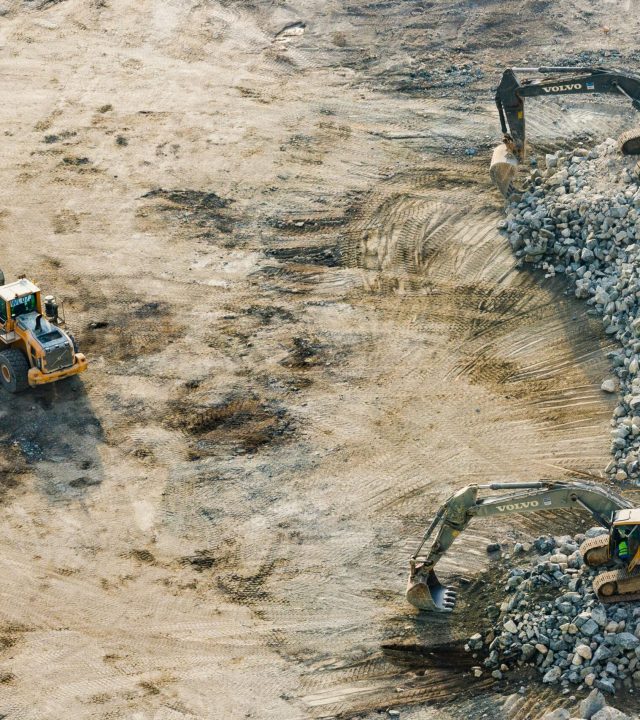 Aerial shot of heavy machinery working on a construction site in Dubai.
